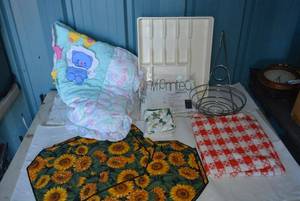 lot 44 image: Sunflower Placemats, Vinyl Tablecloths, Wire Fruit Stand, Baby Blanket