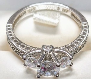 lot 2 image: 3 Stone Cubic Zirconia Ring with 6 smaller CZs on each side. Mounted on .925 Silver Band   ALERT  MORE SILVER ADDED SINCE THE POSTING OF THIS AUCTION