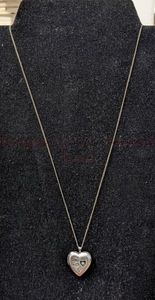 lot 13 image: Sterling Silver Heart and Chain. Heart is approximately 34 long. Chain is 19.5 long.