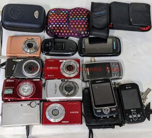 lot 182 image: Several Digital Cameras and their Chargers and cable chargers.