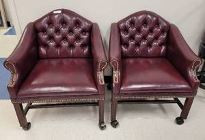 lot 19 image: (2) TUFTED LEATHER-STYLE CLUB CHAIRS WITH WHEELS AS SHOWN. EACH APPROX. 29.5 W x 25 D x 34.75 H. SOLD 2 X THE MONEY