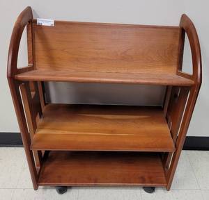 lot 21 image: SOLID WOOD BOOK CART WITH WHEELS AS SHOWN. APPROX. 25 W x 13 D x 31.5 H.