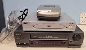 lot 25 image: (1) APEX DVD VIDEO PLAYER MODEL AD-1110, (1) HITACHI VCR MODEL VT-MX4410A, AND (1) DYNEX VIDEO CASSETE REWINDER MODEL DX-VR101 AS SHOWN.
