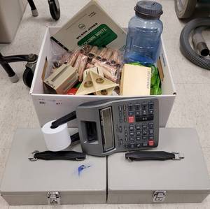 lot 477 image: (2) CASH BOXES, CASIO ADDING CALCULATOR, AND MONEY COUNTING  WRAPPING SUPPLIES AS SHOWN.