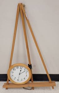 lot 489 image: WOODEN EASEL AND WALL CLOCK AS SHOWN. EASEL APPROX. 22 W x 35.5 H.