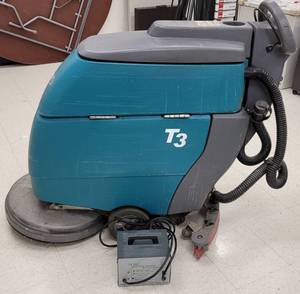 lot 491 image: TENNANT 20 INCH DISC FLOOR SCRUBBER MODEL T3 WITH 24 VOLT DUAL MODE BATTERY CHARGER AND ACCESSORIES AS SHOWN. SEARCH IT UP