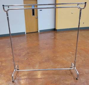 lot 601 image: CHROME ROLLING CLOTHES RACK AS SHOWN. APPROX. 61 W x 66.75 H x 14.5 D.