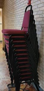 lot 613 image: (12) FABRIC UPHOLSTERED STACK CHAIRS IN STYLE AND COLOR SHOWN. CART NOT INCLUDED SOLD 12 X THE MONEY