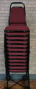 lot 702 image: (12) FABRIC UPHOLSTERED STACK CHAIRS IN STYLE AND COLOR SHOWN. CART NOT INCLUDED SOLD 12 X THE MONEY