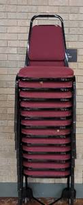 lot 716 image: (12) FABRIC UPHOLSTERED STACK CHAIRS IN STYLE AND COLOR SHOWN. CART NOT INCLUDED SOLD 12 X THE MONEY