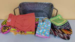 lot 738 image: DECORATIVE BASKET WITH ASSORTED KITCHEN POT HOLDERS, APRONS AND MORE AS SHOWN.