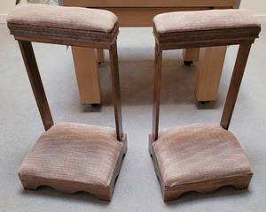 lot 773 image: (2) WOODEN PADDED KNEELERS WITH INTRICATE CARVED DESIGN AROUND THE TOP AS SHOWN. EACH APPROX. 21 W x 18.25 D x 38 H. SOLD 2 X THE MONEY