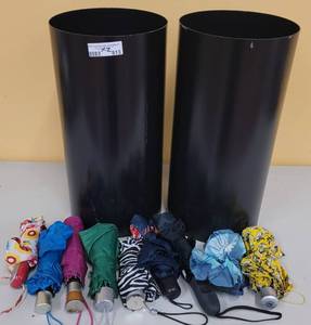 lot 813 image: (2) STEEL UMBRELLA HOLDERS WITH VARIOUS UMBRELLAS AS SHOWN. EACH APPROX. 10 Dia. x 20 H. SOLD 2 X THE MONEY