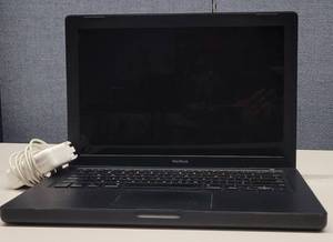 lot 827 image: APPLE MACBOOK MODEL A1181 WITH CHARGER AS SHOWN. NO HARD DRIVE.