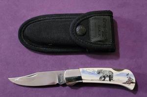 lot 49 image: SABRE KNIFE WITH FAUX SCRIMSHAW DESIGN AS SHOWN.