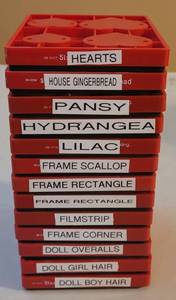 lot 54 image: SIZZIX LARGE RED DIE CUTTERS IN STYLES AS SHOWN. (SOLD 13 X THE MONEY)
