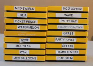 lot 83 image: SIZZIX MEDIUM YELLOW DIE CUTTERS IN STYLES AS SHOWN. (SOLD x18 THE MONEY)