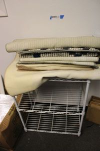 lot 518 image: 2 Shelf White Wire Rack and Small Accent Rugs