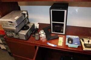 lot 512 image: Contents on Desk Projectors, Adding Machine, Mouse, Chargers and Microphone, CD Holder