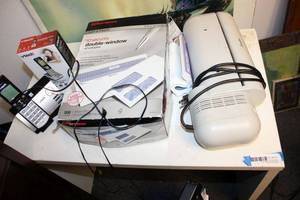 lot 513 image: Small White Table, Window Envelopes, V-Tech Phone, and Swingline Electric Punch Model 525