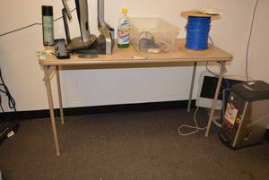 lot 579 image: Cosco Folding Table CONTENTS NOT INCLUDED