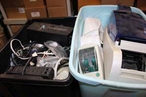 lot 286 image: Tubs of wall warts and power adapters, Battery Backup Model XP400 and label printers and paper rolls