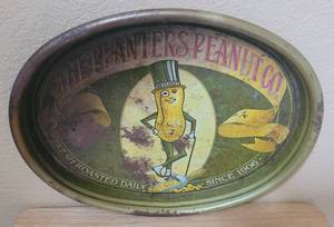 lot 15 image: VINTAGE PLANTERS PEANUT COMPANY ADVERTISING METAL TRAY AS SHOWN. APPROX. 15 W x 12.5 H.
