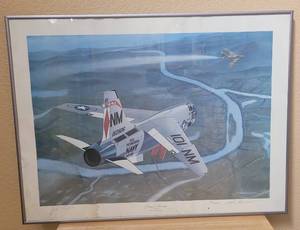 lot 28 image: VINTAGE 1988 FRAMED LIMITED EDITION 3131000 SIGNED PIRATES BOUNTY 9 JULY 1968 - JOHN NICHOLS III F-8 CRUSADER PRINT AS SHOWN. SIGNED BY JOHN NICHOLS III AND MIKE MACHAT. APPROX. 18.25 W x 24.5 H.