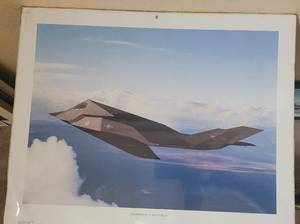 lot 32 image: VINTAGE 1991 LOCKHEED F-117A STEALTH POSTER AS SHOWN. THIS ITEM STILL HAS THE ORIGINAL PLASTIC WRAP. APPROX. 20 W x 16 H.