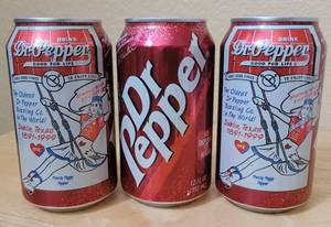 lot 58 image: (3) 1999 DR. PEPPER THE OLDEST DR. PEPPER BOTTLING CO IN THE WORLD -- DUBLIN, TEXAS 1891-1999 COMMEMORATIVE 12 OZ UNOPENED CANS DEPICTING PRETTY PEGGY PEPPER AS SHOWN. (SOLD 3 X THE MONEY)
