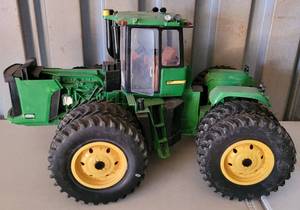 lot 3 image: JOHN DEER MODEL  TOY TRACTOR AS SHOWN. CHECK IT OUT APPROX. 15 W x 13.5 H x 24 D.