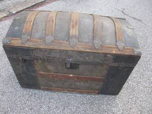 lot 43 image: 1900s  Wood And Metal Humpback  Dome Trunk With Original Metal Wheels,