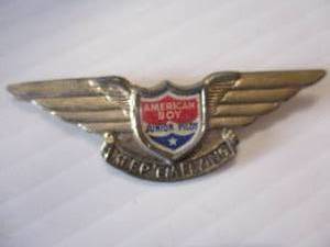 lot 52 image: VINTAGE- AMERICAN BOY JUNIOR PILOT BADGE, KEEP EM FLYING CHAMPION PRODUCTS CO. Pinback Badge