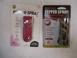 lot 79 image: HIS AND HERS -PEPPER SPRAY, 1-CHEETAH AND 1-GUARD DOG, BOTH WITH STYLISH KEYCHAINS.