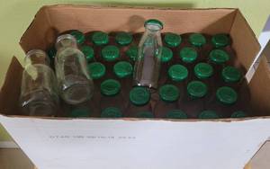 lot 25 image: LOT OF 37 CLEAR GLASS BOTTLES WITH LIDS AS SHOWN.