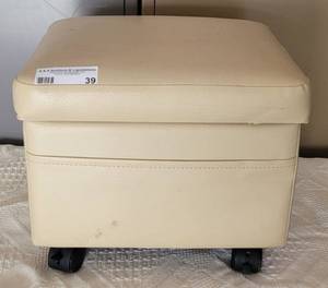 lot 39 image: OTTOMAN WITH STORAGE SPACE WITH WHEELS IN COLOR AS SHOWN. APPROX. 13.5 W X 10.5 D X 11.5 H.