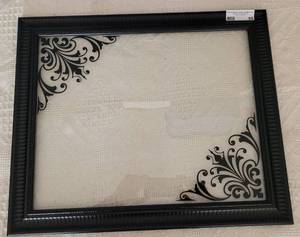 lot 55 image: BLACK DECORATIVE FRAME WITH GLASS IN DESIGN AS SHOWN. APPROX. 19.25 W X 23.25 H.