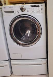 lot 46 image: LG STEAMWASHER MODEL WM2487HWMA WITH PEDESTAL AND MANUAL AS SHOWN. THIS UNIT WAS STILL CONNECTED WHEN PICTURES WERE TAKEN.