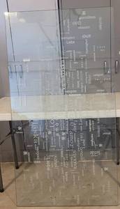 lot 49 image: HEAVY TEMPERED GLASS DESKTOP WITH VINYLIZED LOVE IN MANY LANGUAGES AS SHOWN.