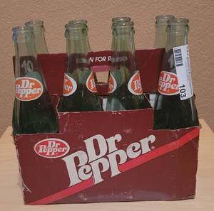 lot 103 image: VINTAGE DR. PEPPER 8-PACK 10 OZ GLASS BOTTLES WITH CARRIER AS SHOWN.