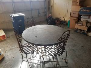 lot 127 image: Round table with 4 very heavy wrought iron chairs -  DIFFERENT LOCATION - Pickup 011722