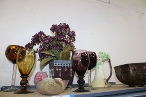 lot 137 image: Purple and Brown Glassware (Tallest is 10.5), Metal Planter with Purple Artificial Flowers and Brass Planter with Red Tile Stones