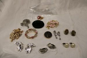 lot 204 image: Signed brooch assortment. Includes a Regency domed glass pin, Lisner, Coro earrings, Monet, Trifari, LCI, Vogue, Royal