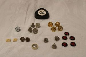 lot 207 image: Colt, Colt Sauer and other Vintage Sporting Rifle Grip Cap Inlay Medallions as shown