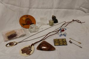 lot 209 image: Owl collectibles. Includes a glass owl, owl stick pins and necklaces. Also included is a carved stone coyote and glass turtle