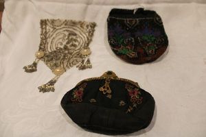 lot 212 image: Handbag trio. Includes an early Victorian (1850-1900) hand beaded waist decoration, 1940s Graceline hand bag w crewel needlepoint decoration and glass faceted embellished metal frame, Beaded purse body.