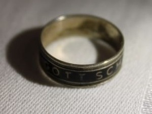 lot 216 image: Sterling Silver (unmarked) and black enamel band ring. Inscribed Gott Schutze Dich (God Bless or May God Protect You). Size 8