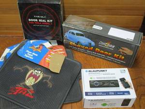 lot 112 image: AUTO ACCESSORIES- AMFM BLUETOOTH MEDIA RECEIVER WORKS WITH ANDROID AND IPHONE IN BOX, DOOR SEAL KIT FOR TESLA IN BOX, LOONEY TUNES TAZ FLOOR MATS, AUTOLOC SHAVED DOOR KIT