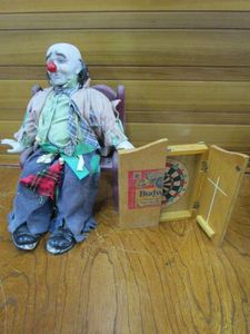 lot 113 image: VINTAGE 1983 DYNASTY PORCELAIN DOLL CLOWN HOBO WITH WOODEN CHAIR, SMALL WOODEN BUDWEISER DARTBOARD