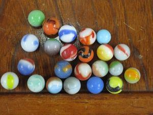 lot 173 image: 23 HARD TO FIND ANTIQUEVINTAGE MARBLES, BELIEVED TO BE HANDMADE SLAG MARBLES DUE TO THE PONTIL MARK THAT CAN BE FOUND ON THE MAJORITY, GLASS JAR INCL., 1 HAS A BREAK PICTURED IN LAST PICTURES